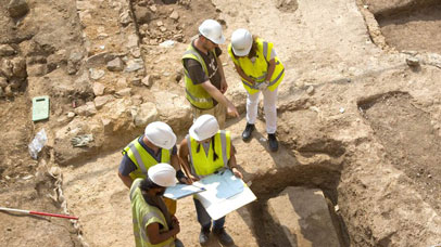 Archaeologists conferring on a dig site