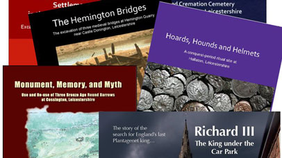 A mix of archaeology books overlapping one another.
