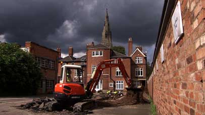 Digger in the middle of a car park