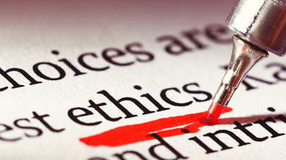 Close up of the word 'ethics' in a paragraph, being underlined by a red pen.