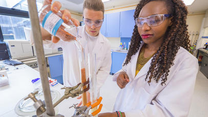Two female Chemistry students at work in a lab