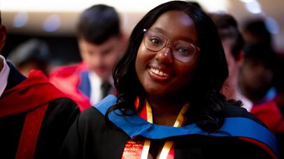 Smiling student looking to the camera during Graduation ceremony