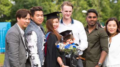 Graduate posing for a picture with family