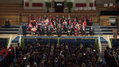 Academics and speakers on stage at graduation ceremony