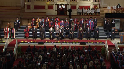 Group of academics and speakers on stage at graduation ceremony