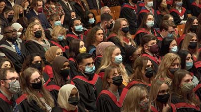 Crowd of graduands sitting down at graduation ceremony