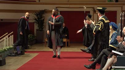 Graduate on stage at graduation