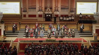 People on stage at DMU during graduation