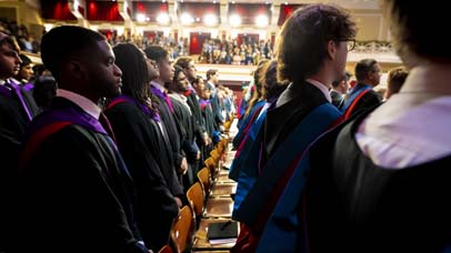 A side on view of the students during the ceremony in De Montfort Hall