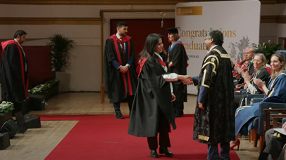 University of Leicester Vice Chancellor shaking hands with Graduate at the 2.30pm ceremony at De Montfort Hall