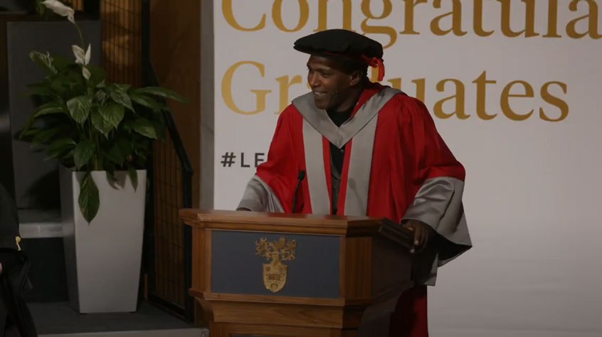 Poet Lemn Sissay speaking at a podium after receiving an honorary degree