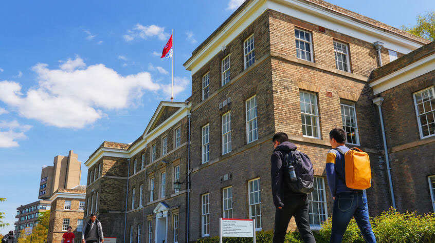 Students walking past the Fielding Johnson building on University of Leicester campus.