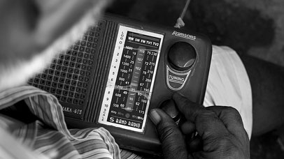 Man adjusting radio