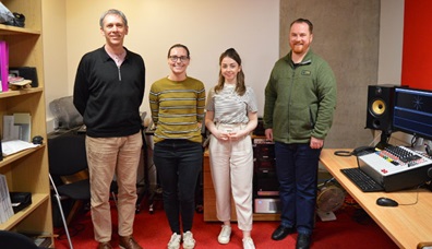 A photo of the members of the Sounds for the Future team standing next to audio equipment.