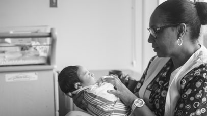 Nurse holding a baby.