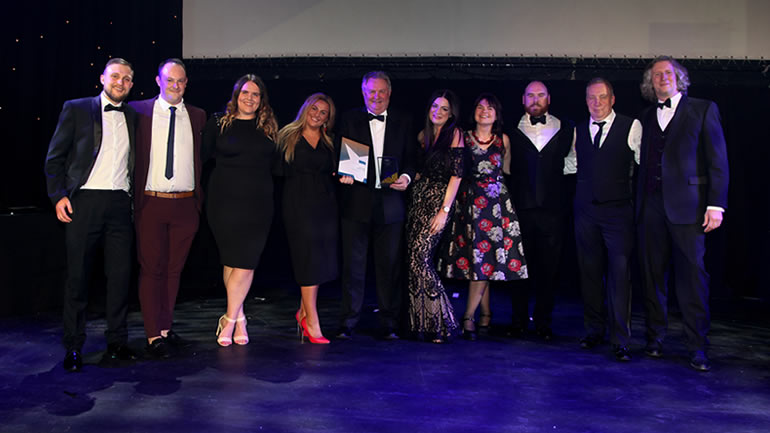 People showing off their tourism award