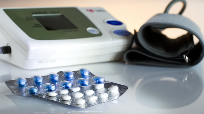 Blood pressure pills next to blood pressure monitor