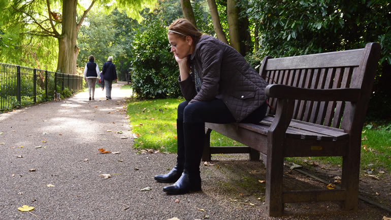 Lonely woman on bench