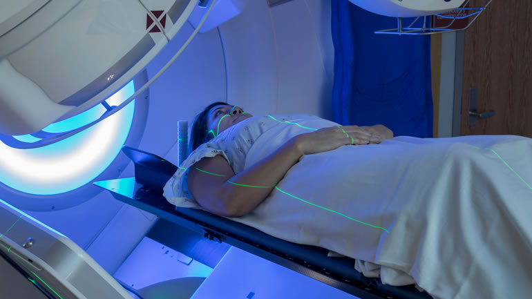 Woman undergoing radiotherapy treatment