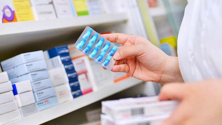 Pharmacist selecting antibiotics