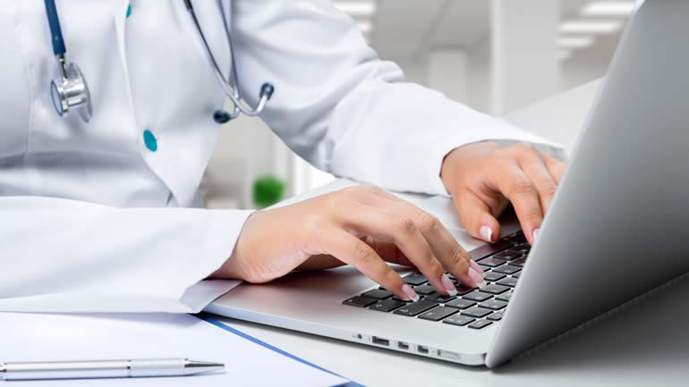 A hospital doctor using a laptop