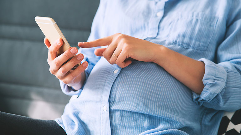 Pregnant woman using phone