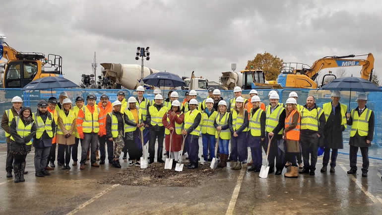 A group of people on a construction site posing for a photo