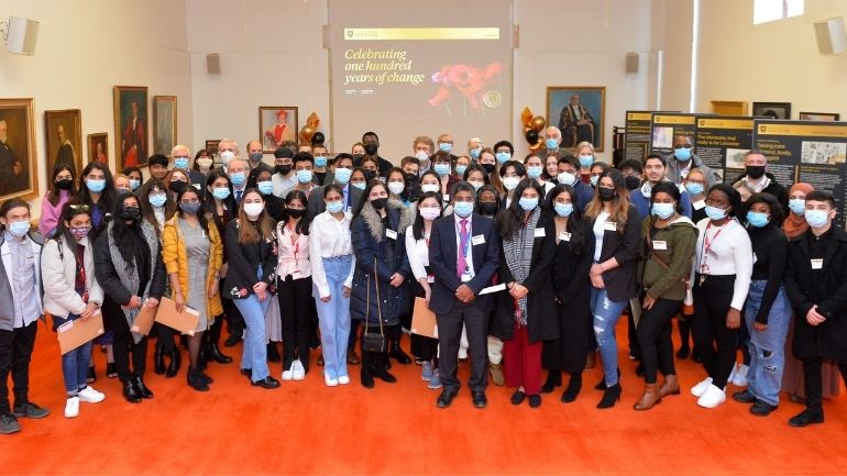A group of Leicester scholarship holders celebrate in the University's Council chambers.