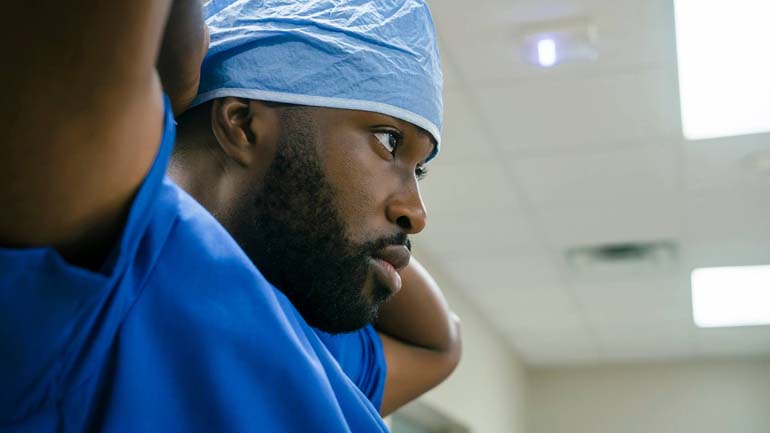Hospital staff member looking on