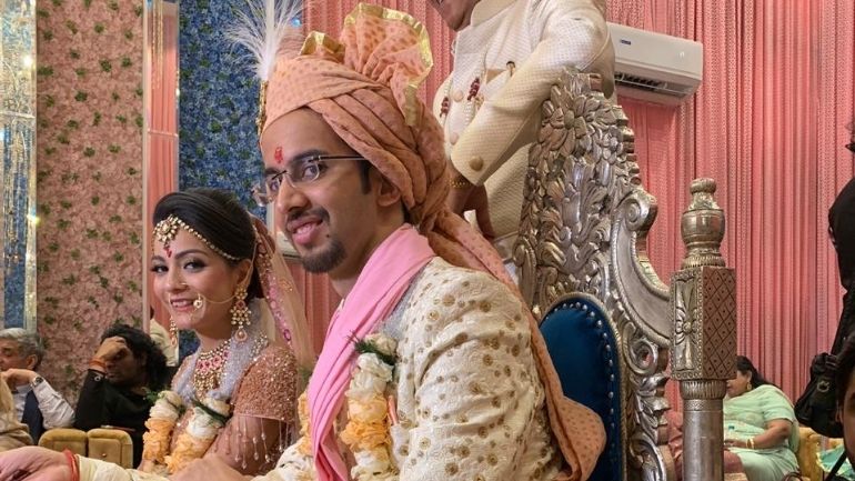 A young couple in traditional Hindu wedding attire.