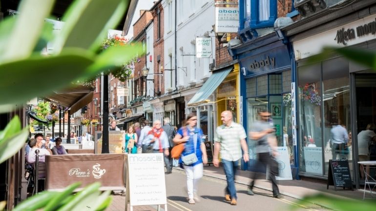 Shoppers on a busy street in Leicester.