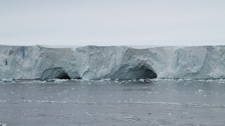 The edge of an Antarctic ice sheet, with ocean in the foreground.