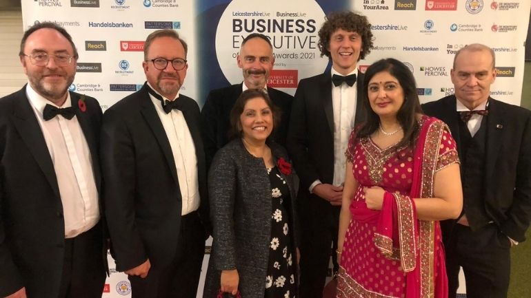 A group of people in front of LeicestershireLive Business Executive of the Year Awards signage.