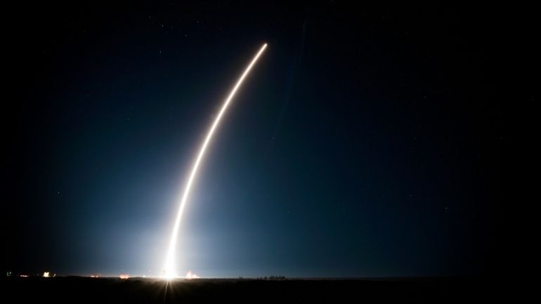A rocket is launched against the night sky.