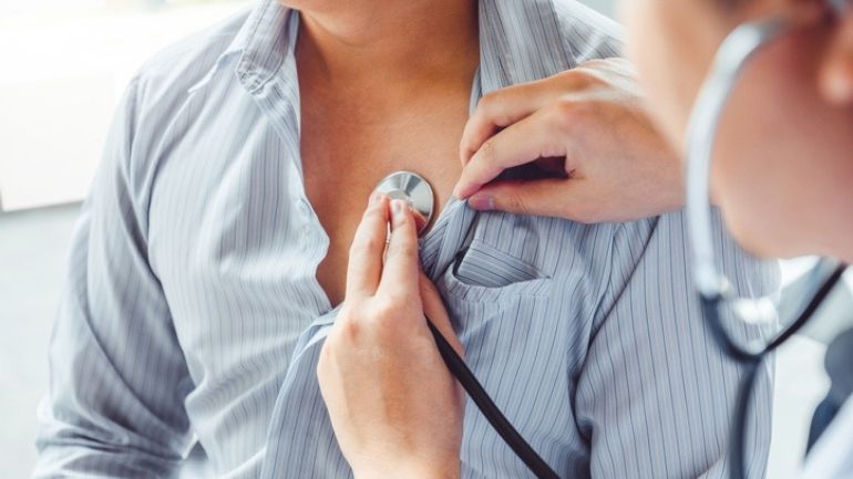A stethoscope placed on a patient's chest.