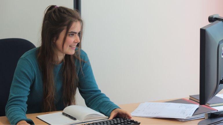 Amelia Markfort working at a desktop computer.