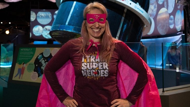 Dr Sandra Lee wearing a superhero cape and mask at the launch of the National Space Centre's Home Planet gallery.