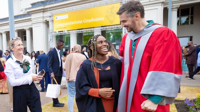 Olivia Lewis takes a picture with honorary graduate Richard Armitage outside De Montfort Hall.