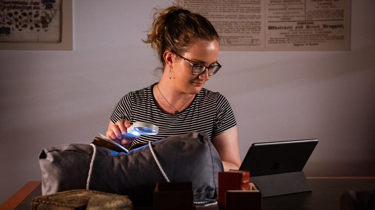 A researcher processes data on a museum object.