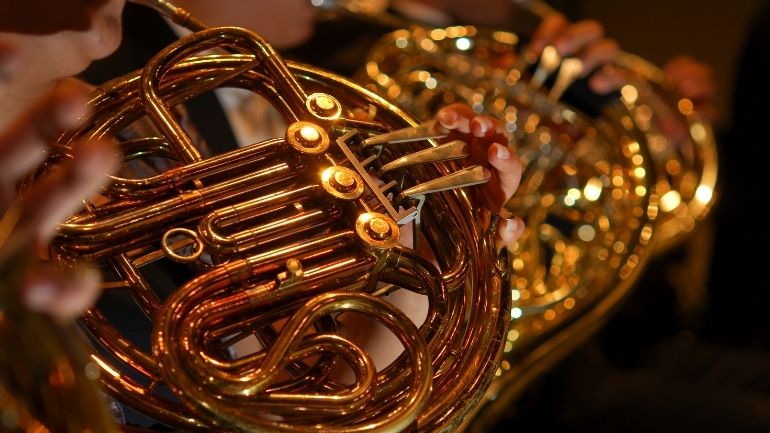 Close-up of brass instruments being played.