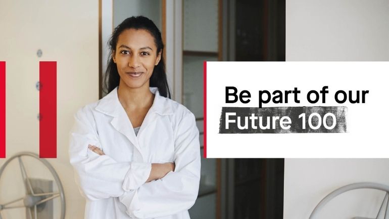 A young researcher wearing a white lab coat smiles at the camera, next to the words 'Be part of our Future 100'.