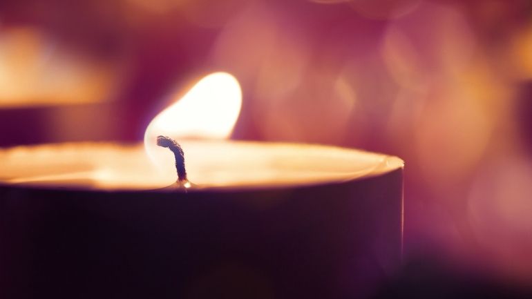 A single burning candle.