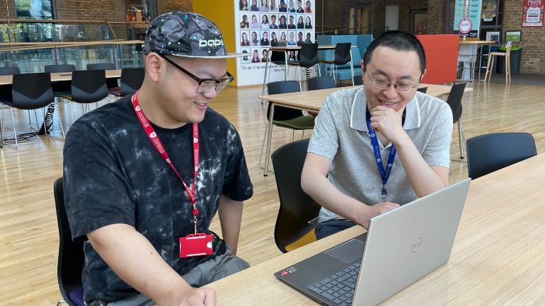 Siyuan Lu and Professor Yudong Zhang sat a computer screen.