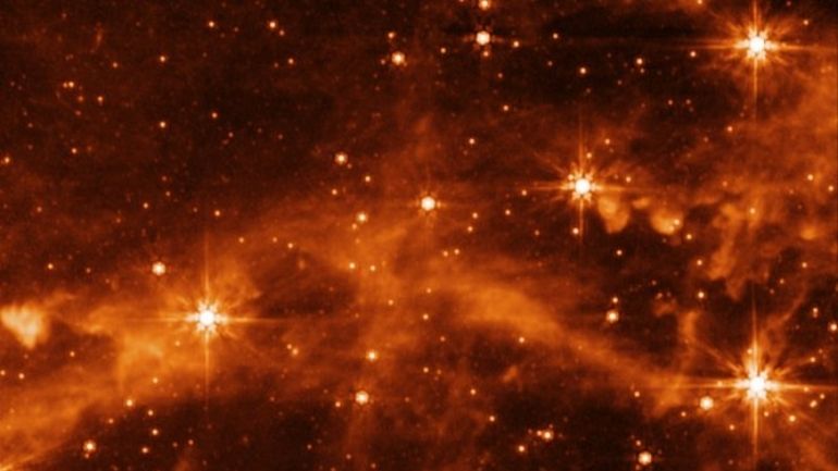 View of distant stars and galactic clouds captured by MIRI.