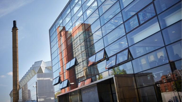 Reflection of Leicester's Engineering Building in the windows of the David Wilson Library.
