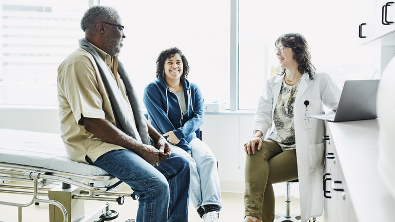 A doctor speaking with patients.