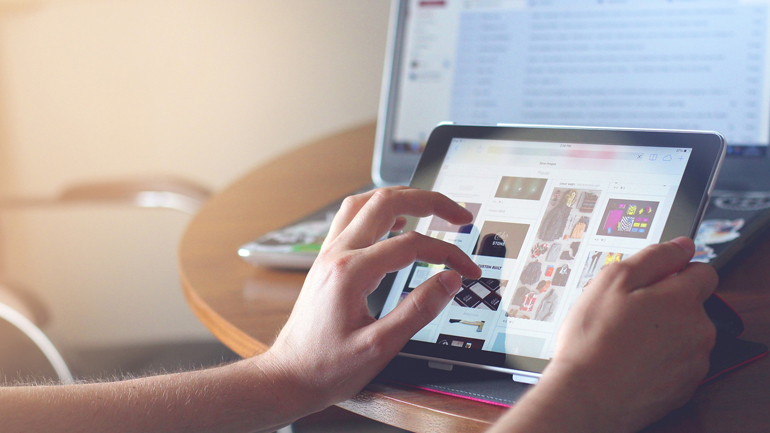 Someone using digital technologies, such as tablets and laptops.