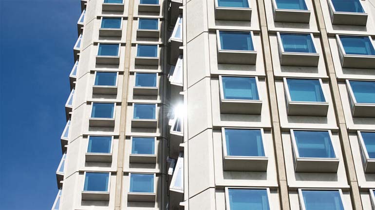 Image showing part of Attenborough Tower on University of Leicester campus against blue sky