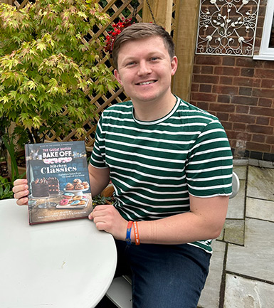 Dr Josh Smalley with this years Great British Bake Off recipe book.