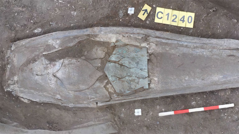 The lead coffin containing the remains of Edward Entwistle Wilkinson, showing both the pentagon-shaped brass nameplate from the outer wooden coffin, and the shield-shaped lead motif on the inner lead coffin. Image: ULAS